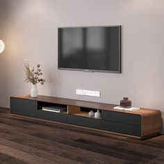 a flat screen tv mounted to the side of a wooden entertainment center in a living room