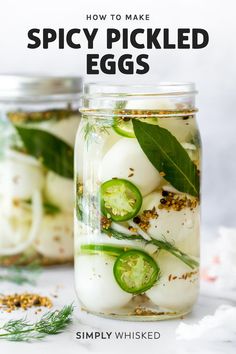 a jar filled with pickles and cucumbers on top of a white table