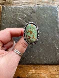 Handmade Pilot Mountain Turquoise and sterling silver statement ring.  -Ring will fit US Size 10.5 American Southwestern Vintage style design. Beautiful Minty green color with warm brown matrix.  High Grade Pilot Mountain turquoise stone. Chunky twisty rope like trim, and freeform shape. Hand polished Rustic looking patina with high polish finish.  chunky Double split style shank/band.  Hand stamped Rising Sun and Arrow hallmark on backside. Turquoise stone is from the Pilot Mountain mine in Nev Southwestern Green Turquoise Ring With Large Stone, Southwestern Style Green Turquoise Ring As Gift, Southwestern Style Green Turquoise Ring With Large Stone, Unique Green Turquoise Ring, Artisan Green Turquoise Ring As Gift, Artisan Green Turquoise Ring For Gift, Artisan Green Turquoise Ring Gift, Unique Green Turquoise Ring With Large Stone, Green Oval Turquoise Artisan Ring