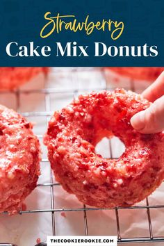 strawberry cake mix donuts on a cooling rack with text overlay reading strawberry cake mix donuts