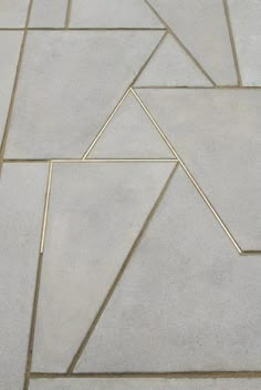 a white tile floor with lines and shapes on the top one is diagonally arranged