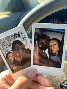 two polaroids are held up in the car