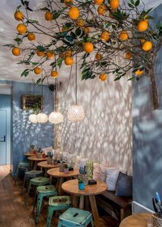 an image of a restaurant with oranges hanging from the ceiling and on the wall