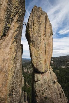 a person standing on top of a large rock