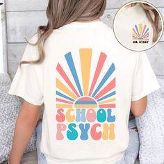 Introducing our personalized school psychologist Comfort Colors® t-shirt, perfect for showcasing your profession in style! The front pocket design features a vibrant display of colorful sunrays with your custom name elegantly placed underneath, adding a personal touch. On the back, the same eye-catching sunrays accompany retro colorful text reading "School Psych", making a statement wherever you go. This unique and comfortable t-shirt is a must-have for any dedicated school psychologist looking White Graphic T-shirt For School, White Graphic Design T-shirt For School, Relaxed Fit Screen Print T-shirt For School, White Retro T-shirt For Back To School, Relaxed Fit School T-shirt With Screen Print, White Retro T-shirt For School, Retro White T-shirt For School, White Relaxed Fit T-shirt, School T-shirt With Graphic Design, Crew Neck