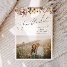 a save the date card on top of a blanket with an image of a man and woman