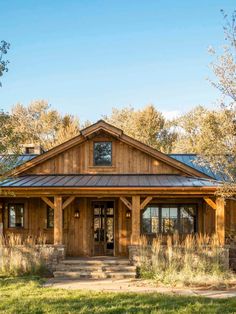 a rustic style house with a metal roof and wood trimmings on the front