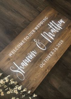 a wooden sign that says welcome to our wedding and the date is shown on it