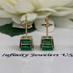 "These earrings are radiant cut lab created green emerald studs, 14k yellow gold #6228 -Approximate total carat weight: 3.50ctw diamond equivalent -Stone Size: approx. 1.75ct each diamond equivalent -Gem Type: emerald -Stone Shape: radiant cut 7x7mm each -Stone Clarity: VS2 -Stone Color: green -Moh's Scale: 8.5 Hardness -Metal Type and Purity: 14k yellow gold -Setting: 4 prong basketsetting -Backing: screw back (earring backs are subject to change due to availability) -Country of Manufacturing: Green Baguette Cut Earrings For Formal Occasions, Green Baguette Cut Earrings For Gifts, Gia Certified Green Earrings In Fine Jewelry Style, Gia Certified Green Earrings Fine Jewelry, Gia Certified Green Fine Jewelry Earrings, Green Gia Certified Fine Jewelry Earrings, Green Prong Setting Earrings In Fine Jewelry Style, Green Earrings For Anniversary, Green Emerald Earrings With Prong Setting