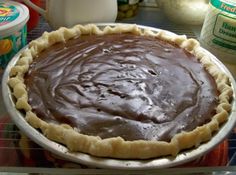 a chocolate pie sitting on top of a metal pan