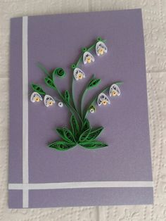 a purple card with white flowers on it