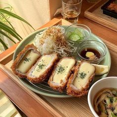 an assortment of food on a plate with dipping sauce