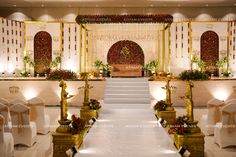 an indoor wedding venue with white and gold decor