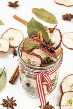 an apple spice mix in a glass jar with cinnamon sticks and star anise on the side