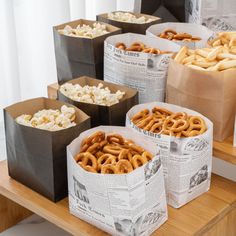 several paper bags filled with pretzels and popcorn