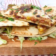 two quesadillas stacked on top of each other with lettuce and cheese