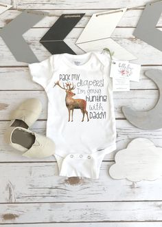 "\"Pack my diapers! I'm going hunting with Daddy!\" This hunting baby bodysuit or t-shirt is perfect for your newest hunting buddy! This design makes a great baby shower gift for the outdoorsy family that loves hunting! The design is grey and the buck is a watercolor style design. Makes a wonderful keepsake and pregnancy reveal gift! When ordering, \"S/S\" means Short Sleeves, and \"L/S\" means Long Sleeves. The baseball style tees with colored sleeves are listed as RAGLAN TEES. Raglan tees have Uncle Onesie, Hunting Onesie, Aunt Onesie, Deer Theme, Pregnancy Reveal Gifts, Baby Aunt, Hunting Baby, Thomas Wayne, Pregnancy Reveal Shirt