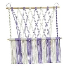 a purple and white macrame hanging on a wall