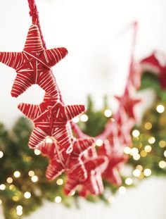 some red and white ornaments hanging from a christmas tree