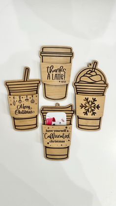 four wooden christmas ornament designs with coffee cups and snowflakes on them