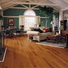 a living room with hard wood floors and green walls