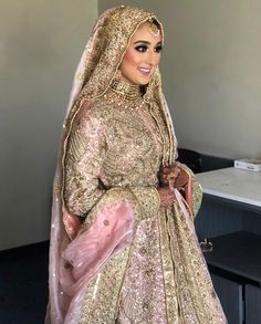 a woman in a bridal gown posing for the camera with her hands on her hips