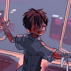 a boy with his arms out in front of a window