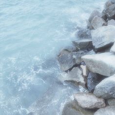 some rocks and water near the shore