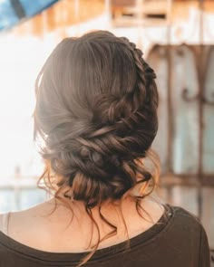 the back of a woman's head with braids in her hair