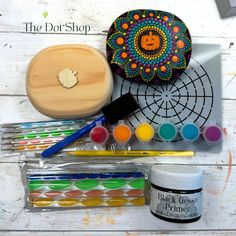 an assortment of crafting supplies sitting on top of a white wooden table with the words, the dot shop