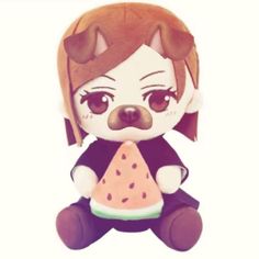 a small stuffed animal is holding a piece of watermelon