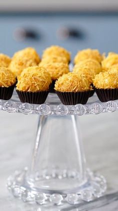 several cupcakes on a clear cake plate