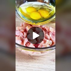 an image of eggs and meat in a bowl on a table with other food items