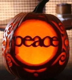 a carved pumpkin with the word peace on it