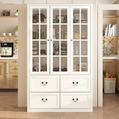 a white china cabinet with glass doors in a kitchen