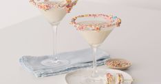 two martinis with sprinkles on the rim and one filled with ice cream