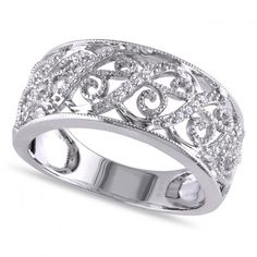 a white gold ring with diamonds in the middle and an intricate design on it's side