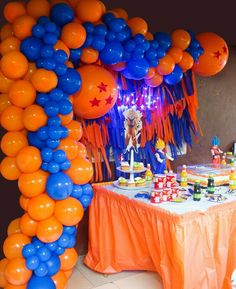 an orange and blue balloon arch with decorations