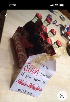 coca - cola bottles are sitting on a table next to a sign that says soda is limited if you went to coke with me