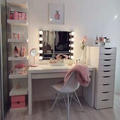 a white desk topped with lots of drawers and a mirror next to a shelf filled with pink items