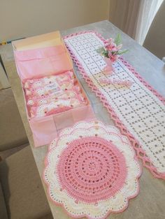 crocheted table runner and placemats on top of a table in a living room