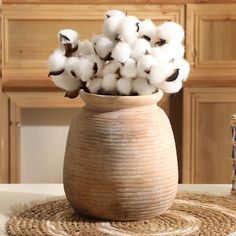 a vase filled with cotton sitting on top of a table