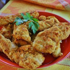 fried chicken on a red plate with parsley