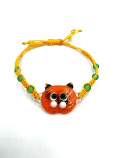 * Handcrafted glass orange cat bracelet, designed and created with love. Elegant, cute handmade glass garfield bracelet . Bright, beautiful, comfortable to wear with both elegant and trendy clothes. Eye-catching, very pretty  glass cat bracelets. Each jewel is specifically designed for women and kids.   * If you like this beautiful green eyes cat bracelet, feel free to go to our Etsy Shop to see the rest our products: https://www.etsy.com/uk/shop/TheGlassUniverse  * More Bracelets: https://www.etsy.com/uk/shop/TheGlassUniverse?section_id=32730569 * High wearing comfort! All bracelets are highly sustainable as the are made of high-quality materials.  *  Individually handcrafted glass orange cat bracelet made with love out of handmade glass. Each jewel is absolutely unique  and customizable. Beaded Cat, Beautiful Green Eyes, Cat Tee Shirts, Garfield Cat, Cat Bracelet, Cat Bead, Beaded Jewels, Bracelet Beaded, Orange Cat