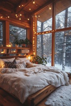 a bed in a room with lights on the ceiling and windows above it, surrounded by snow covered ground