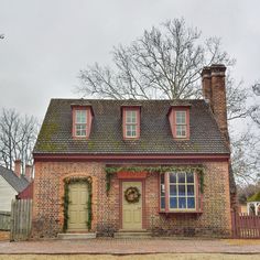 an old brick house with wreath on the front door