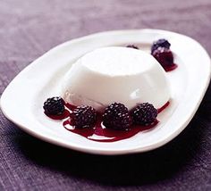 a small white plate topped with berries and ice cream