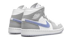 The Women’s Air Jordan 1 Mid “Wolf Grey/Aluminum” is a women’s exclusive look for Michael Jordan’s iconic first signature shoe.  Interestingly, the “Wolf Grey/Aluminum” colorway is reminiscent of the white-and-grey color block of the Dior x Air Jordan 1 from 2020, one of the most coveted Air Jordan releases of all time.  Like Dior’s high fashion-inflicted take on the retro basketball shoe, the “Wolf Grey/Aluminum” features white leather on the perforated toe, mid-panel, and collar.  Contrasting Jordan 1 Mid Wolf Grey, Dior Jordan 1's, Air Jordan 1 Mid Grey, Jordan 1 Mid Women, Womens Air Jordan 1, Womens Air Jordan, Retro Basketball Shoes, Jordan Logo, Nike Swoosh Logo