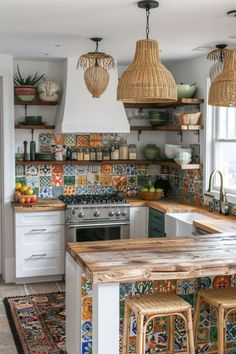 a kitchen with lots of counter space and hanging lights above the stove top, along with wicker stools