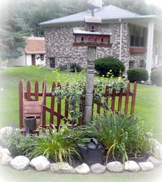 a wooden fence in front of a house with plants growing on it's sides